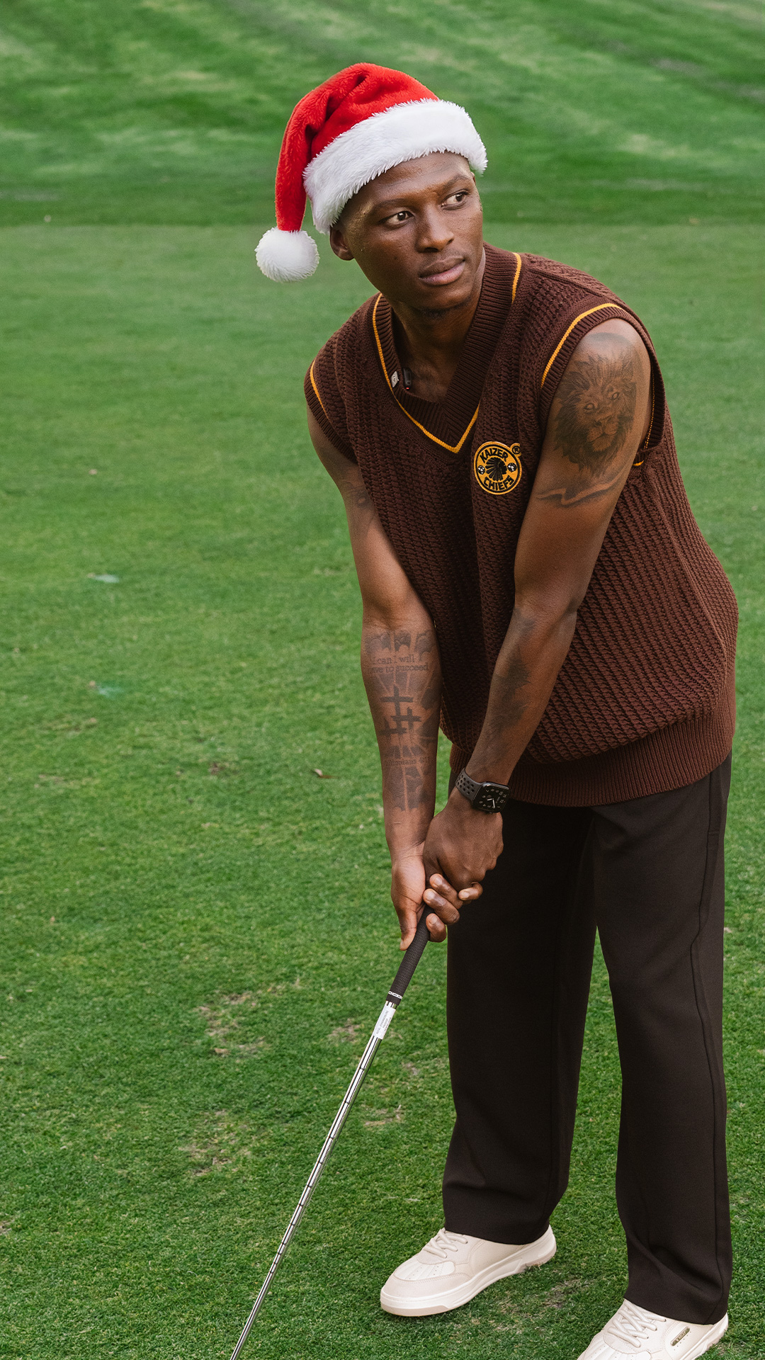 Chiefs vest and Santa hat on a putting green